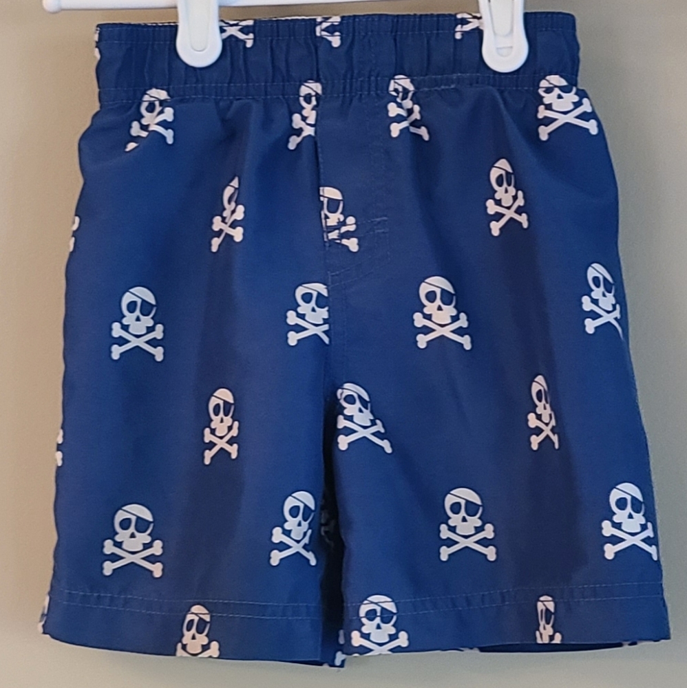 Blue mesh lined swim trunks with skull and crossbones pattern